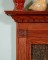 Neatly designed block trim and dentil molding are enhancers for the wood fireplace mantel.