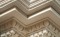Beautifully combined moldings adorn the intricately tiered top mantel shelf
