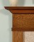 The Killen wood mantel has simple crown molding and fluted legs