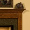 Dentil and picture frame molding are featured on this fireplace mantel