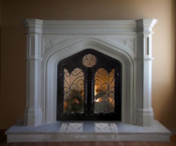 The Gothic Stone Mantel in two sizes. Trefoil design in the spandrels. Wrought iron doors not included.