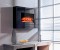 This electric fireplace is shown with the optional absolute black granite facing frame.