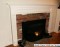 A customer supplied image of their Lewisburg mantel sized to work with a heath that is the same width as the facing on the wall.  The mantel legs 'straddle' the hearth and the scribe molding makes the transition.