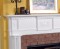 The dentil molding and framed center piece enhances the beauty of the Vancouver fireplace mantel.