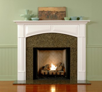 The elegant Lennox custom fireplace mantel has an arched breast