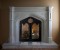 The Gothic Stone Mantel in two sizes. Trefoil design in the spandrels. Wrought iron doors not included.