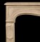 A gentle mantel arch is true to the Louis VX styling