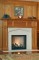 Our Orland wood mantel in Cherry, combined with our limestone Tudor surround and a limestone facing set