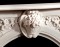 A center arch small basket of flowers is standard with The Andrea English Marble Mantels