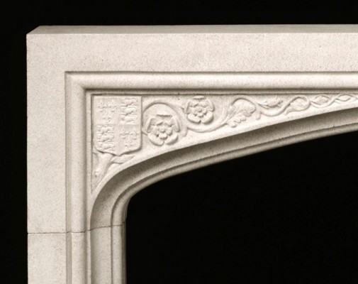 Coat of Arms, acanthus leaves and simple floral details adorn this Tudor fireplace mantel surround.