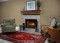 Limestone facing shown with a wood mantel shelf.