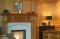 Our Orland wood mantel in Cherry, combined with our limestone Tudor surround and a limestone facing set