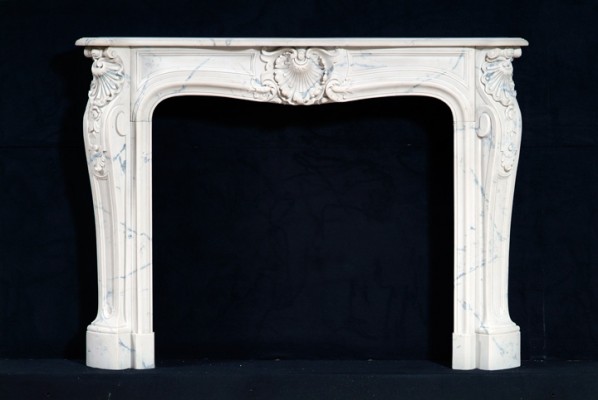 French, Louis XIV styling exhibited in this marble mantel. Carrara marble