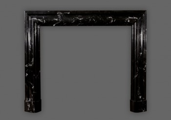 Amazing artwork crafted into the Bolection marble mantel.  Black Regal with white veining